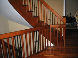 curved maple railings stained to match a tigerwood hardwood